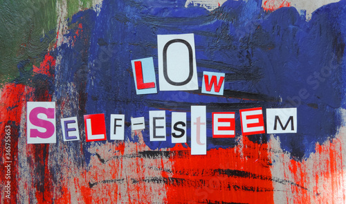 cut out of letters magazines compiled the word low self-esteem on an abstract colorful background