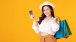 © sopradit - Asian woman holding creadit card and shoppingbag with mid year sale.