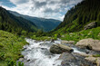 Amazing river waterfall in the heart of the mountains during a sunny day - Romania Fagaras Mountains