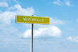 © vallerato - New Skills. Road sign against a blue cloudy sky. New impressions.