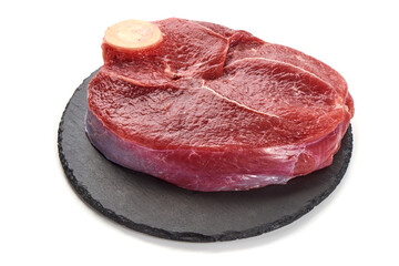 Wall Mural - Fresh raw beef meat with bone for steak on stone plate, isolated on white background