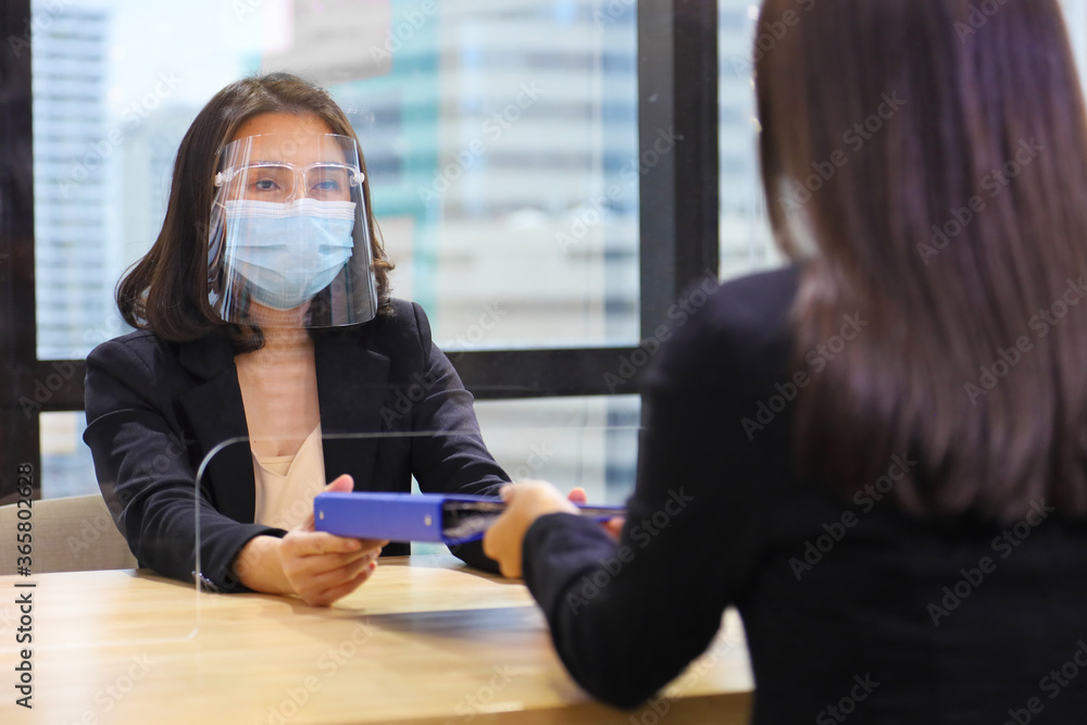 Interview Mask Manager from HR department wearing facial mask is interviewing new ...