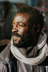 Portrait of the side profile of a smiling black man in a street