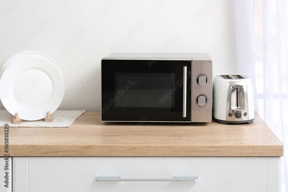 Microwave oven with toaster on kitchen table