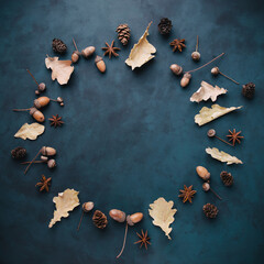 Poster - Autumn floral design greeting card. Fall yellow leaves and acorns wreath on dark surface. Thanksgiving day, seasonal concept. Copy space.