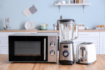 Wall Mural - Different household appliances on table in kitchen