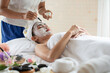 © surachetkhamsuk - Beautiful Asian woman in mask on face in spa beauty salon, enjoying and relaxing time, skin care and healthcare concept