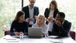 © fizkes - 60s woman mentor teach young multi ethnic employees, group of diverse people analyzing online project offer business strategy, corporate team using computer app involved at brainstorm activity concept
