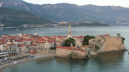 Wall Mural - Budva, Montenegro. Drone footage in the summer morning. View of the Saint Ivan Church and old town. Adriatic coast, in the Mediterranean.