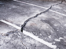 Cement Floor On The Road Damaged And Cracked With Ground Collapse.