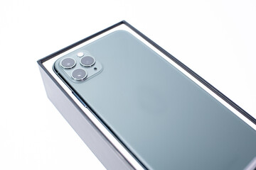 Green smartphone with three cameras on a white background