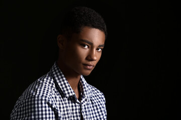 Wall Mural - Sad African-American teenage boy on dark background. Stop racism