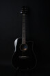 © ARTFULLY-79 - Black acoustic guitar studio shot on black background with copyspace, Guitar is favorite music instrument for hobby.
