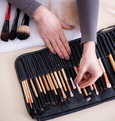 Wall Mural - Make-up artist preparing brushes for work