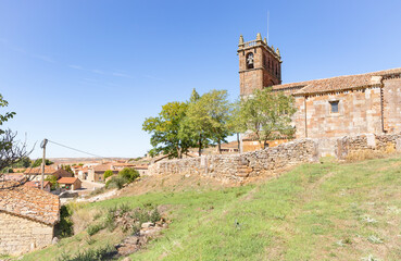 church of the Nativity of Our Lady and a view of Revilla del Campo town, province of Burgos, Castile and Leon, Spain