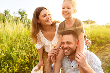 Wall Mural - Daughter smiling and sitting on the neck of her father