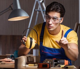 Wall Mural - Worker working in repair workshop in woodworking concept