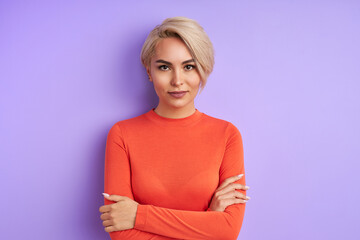 Wall Mural - portrait of confident caucasian lady isolated over purple background. business woman looks at camera, she has strong character