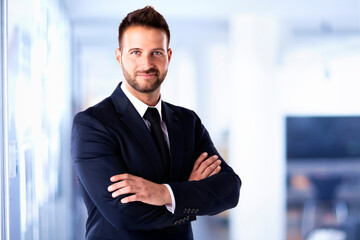 Businessman portrait while standing in the office