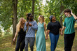 © Roman - american mixed race youth spend time together in the park, friendly men and women have fun, laugh. international love, friendship, tolerance concept