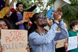 © Roman - young international demonstration participants protesting against climate policy, want to be heard by government, they hold colourful placards in hands