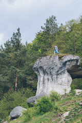 Poster - young hiker man on the top of the cliff