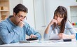 © Elnur - Young couple looking at family finance papers
