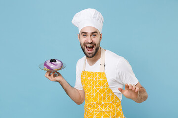 Wall Mural - Cheerful young bearded male chef or cook baker man in apron white t-shirt toque chefs hat isolated on blue wall background studio portrait. Cooking food concept. Mock up copy space. Hold dessert cake.