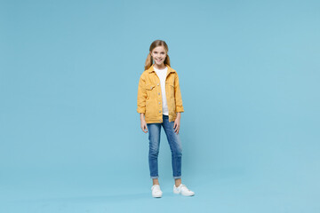 full length portrait of smiling little blonde kid girl 12-13 years old in yellow jacket posing isola