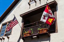 Spanish And US Flags Flying In The Historic District Along Aviles Street, St. Augustine, Florida,USA