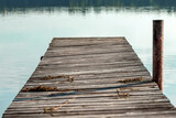 Fototapeta Pomosty - Wooden pier on the background of a beautiful lake summer dawn landscape. Copy space.