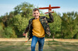 © Aliaksandr Marko - The boy launches a toy airplane against the backdrop of greenery. The concept of dreams, choice of profession, pilot, childhood. Copy space.