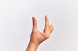 © Krakenimages.com - Hand of caucasian young man showing fingers over isolated white background picking and taking invisible thing, holding object with fingers showing space