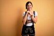 © Krakenimages.com - Young beautiful brunette german woman celebrating Octoberfest wearing traditional dress laughing nervous and excited with hands on chin looking to the side