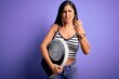 © Krakenimages.com - Young beautiful brunette woman holding weighing machine over isolated purple background annoyed and frustrated shouting with anger, crazy and yelling with raised hand, anger concept