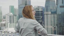 Young Woman Watching The View From Skyscraper