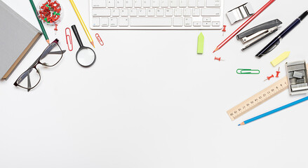 School stationery, student supplies on a white background with copy space. Business stationery pencils, ruler, stapler, keyboard, eye glasses, paper clips and buttons