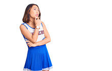 Young Beautiful Chinese Girl Wearing Cheerleader Uniform Thinking Worried About A Question, Concerned And Nervous With Hand On Chin
