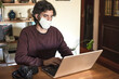 © Jose - Photographer with covid protective mask working from his notebook