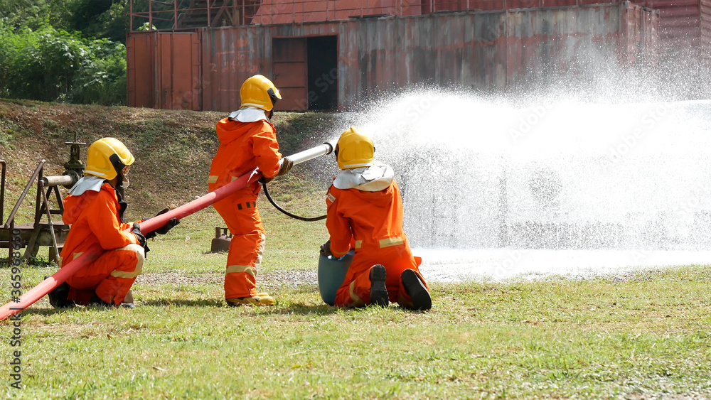 Firefighter fighting with flame using fire hose chemical water foam ...