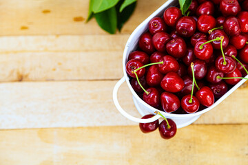 Wall Mural - Ripe sweet cherries on a wooden background.