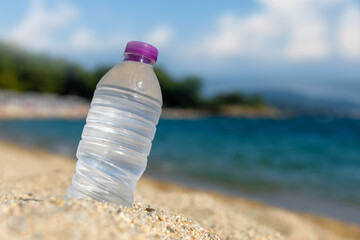 Wall Mural - Bottle of fresh cold water on beach sand