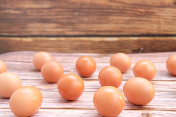 Eggs on wooden table background and space for text 