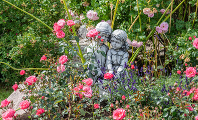 Wall Mural - flowers with sculpture in the garden