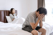 © Kittiphan - Husband feels stressed and pressured from the problem of erectile dysfunction while the disgruntled wife lay in bed after having sex