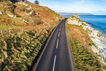 Wall Mural - Causeway Coastal Route a.k.a Antrim Coast Road A2 on the Atlantic coast in Northern Ireland. One of the most scenic coastal roads in Europe. Aerial view in winter