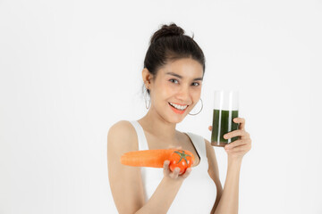 Healthy young Asian woman drinking green detox vegetable smoothie over white isolated background. Vegetarian drink juice, Healthy lifestyle, Fitness and health care concept.