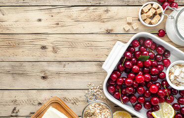Poster - Ingredients for cooking pie with cherries on wooden table with copy space top view