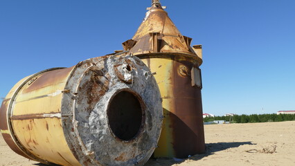 two large rusty old barrels.