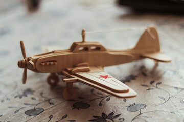 wooden toy airplane on a table with a shallow depth of field